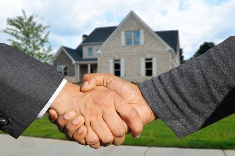 Immobilienbesitzer und Kreditgeber einigen sich per Handshake auf den Abschluss eines Eigentümerdarlehens